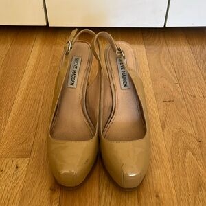 Steve Madden patent sling back pumps.